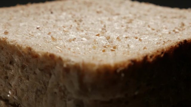 Complete meal bread made of full grain close-up surface 4K 2160p 30fps UltraHD tilting footage - Toast bread pile close-up slow tilt 4K 3840X2160 UHD video