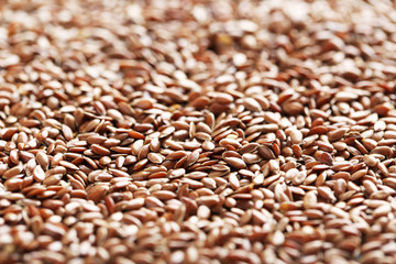 Brown flax seeds on grey wooden table