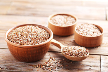 Brown flax seeds on grey wooden table