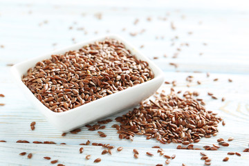 Brown flax seeds on grey wooden table
