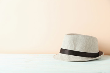 Pretty white hat on a blue wooden table
