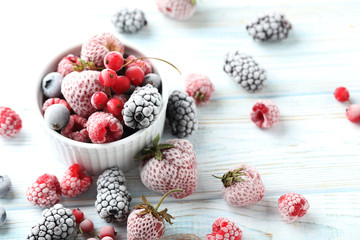 Frozen berries on a white wooden table