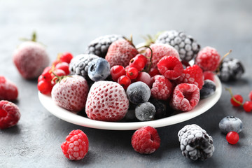 Frozen berries on a black wooden table