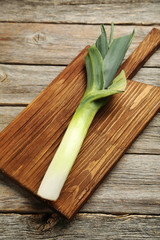 Green leeks on a grey wooden table