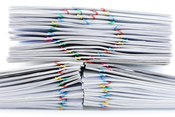 Colorful heart-shaped paperclip on top of pile overload paperwork