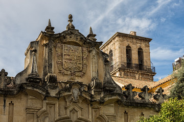 Shield and bell tower in the old town of Cordoba. Spain.