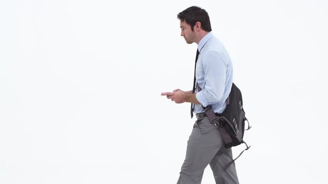 Man texting on phone carrying messenger bag