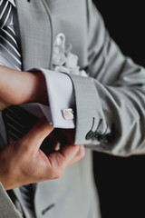 Hands of wedding groom getting ready in suit