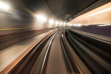 Obraz na płótnie Canvas Fast underground train riding in a tunnel of the modern city