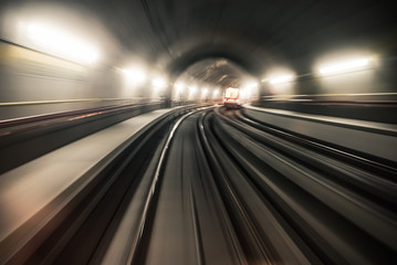Fototapeta na wymiar Fast underground train riding in a tunnel of the modern city