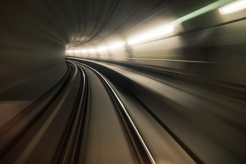 Fototapeta na wymiar Fast underground train riding in a tunnel of the modern city