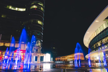 Fototapeta na wymiar Modern Plaza and Colorful Fountains by Night