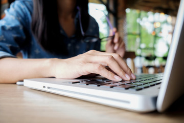 Asia business woman working in coffee shop. Business and modern lifestyle concept: Young woman shopping online at coffee shop. Business concept. Online shopping concept.. © MIND AND I