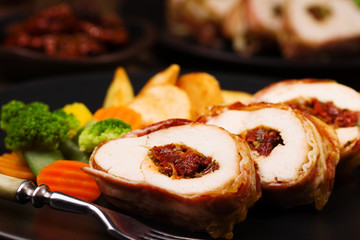 Delicious chicken rolls with dried tomatoes and mozzarella.