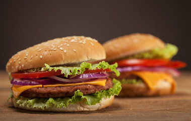 Fresh burgers on wooden background