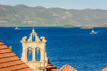  Korcula archipelago Croatia. / View at bell tower of Church of All Saints in town Korcula with marble archipelago in background, Adriatic sea, Croatia.