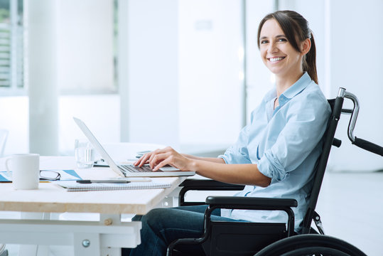 Smiling business woman in wheelchair