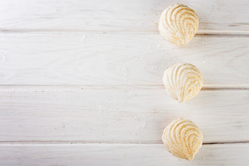  close up sweet zephyrs on white wood background.   Bakery products.