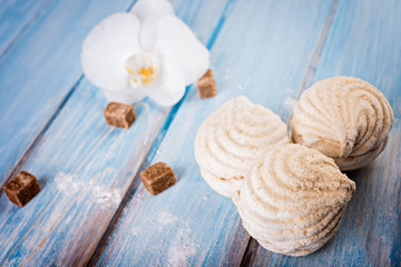  tasty zephyr on blue wooden table, close up. Bakery products on wood background.