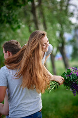 young couple in love walking on the summer park