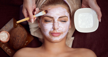 Woman with facial mask at beauty salon