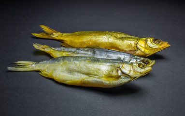 dried fish, beer snack on black background.