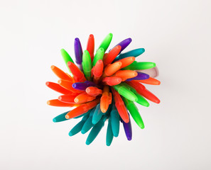 ballpoint pens of different colors on a white background
