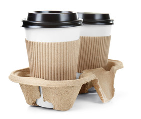 Cups of coffee in holder, isolated on white