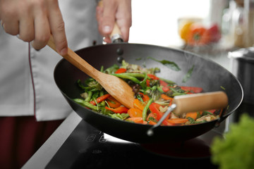 Mixing vegetables in pan closeup