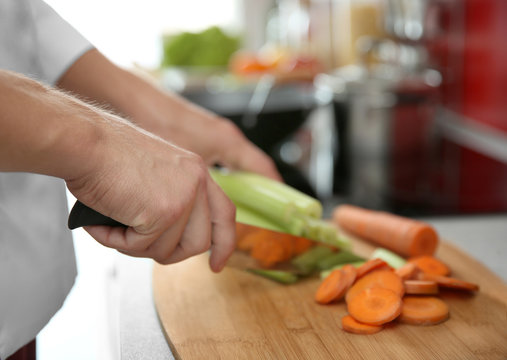 Female hands cutting vegetables on wooden board closeup