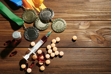 Fototapeta na wymiar Syringe with pills and medals. Doping in sport concept