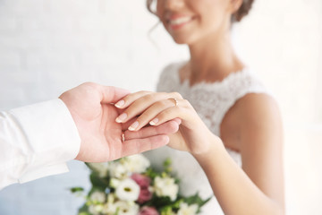 Obraz na płótnie Canvas Groom and bride holding hands closeup