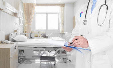 Doctor writing a medical prescription in hospital room