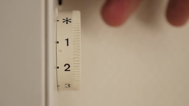 Electirc home convector temperature level adjust on dial 4K 2160p 30fps UltraHD footage - Adjusting thermostat level on home heating electric radiator 4K 3840X2160 UHD video 