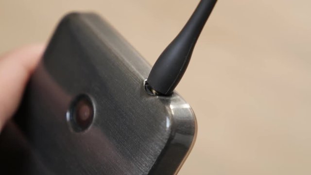 Headphone jack connecting to smart phone close-up 4K 2160p 30fps UltraHD footage - Close-up 3.5 inch headphone plug in mobile phone 4K 3840X2160 UHD video 