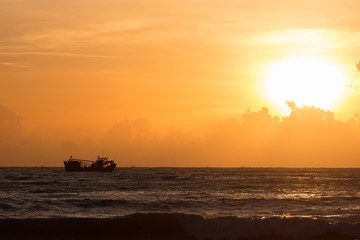 Naklejka na ściany i meble nautical fishing boat in sea with beautiful sky sunrise