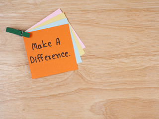 Handwriting word Make a difference on notepaper 1