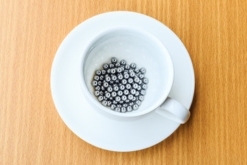 bearings in a dish on wooden table