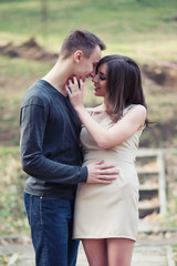 Young, happy and attractive couple enjoying together in the city park. Urban outdoors.