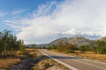 Two-lane asphalt road through a mountain valley in Montenegro