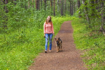 Young woman playing with German shepherd