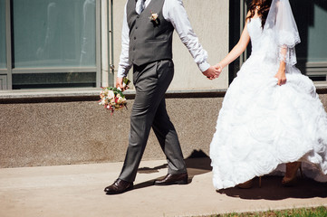 Beautiful wedding bouquet in hands of the groom