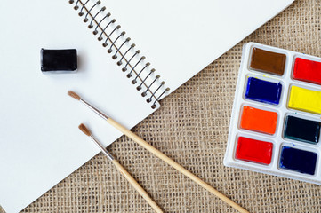 Album for drawing with watercolor and brushes on the sackcloth