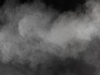 Freeze motion of white dust explosions isolated on black 