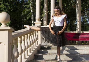 Girl is engaged in a ballet in the park