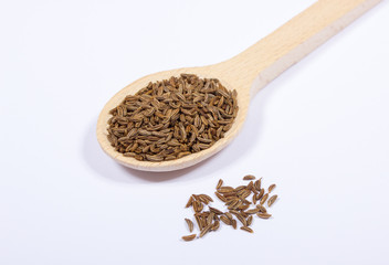 Ground cumin in a spoon.