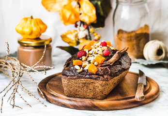 chocolate cake with pumpkin, nuts and frosting, autumn baked