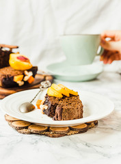 piece of chocolate cake with pumpkin, nuts and fresh peaches on