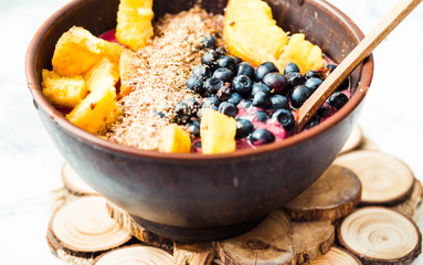 smoothie bowl with peach, blueberry, ground flax and peanut butt
