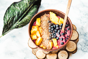 smoothie bowl with peach, blueberry, ground flax and peanut butt
